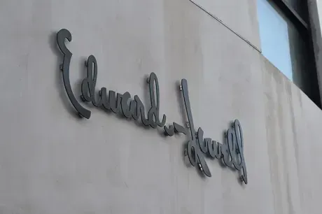 The Edwards-Lowell script wordmark, cast in metal on the Los Angeles building