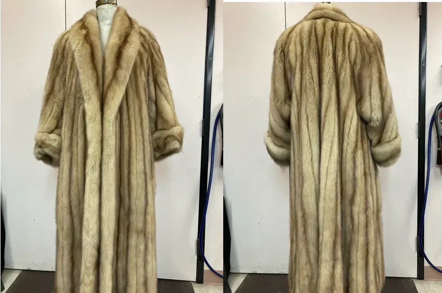 A full-length golden mink coat photographed front and back against the Edwards-Lowell workroom wall